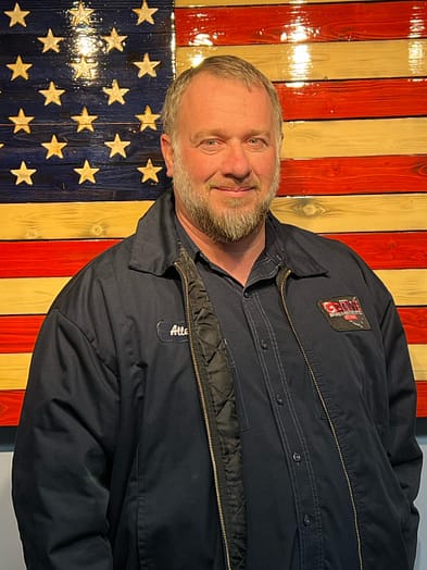 appliance-repairman-allen Appliance repairman with grey beard standing in front of an American Flag.