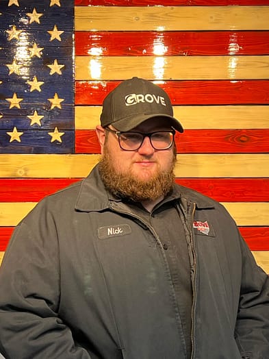 appliance-repairman-nick Appliance repairman standing in front of an American Flag.